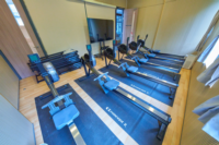 The new fitness room is equipped with six rowing machines and a large TV screen.